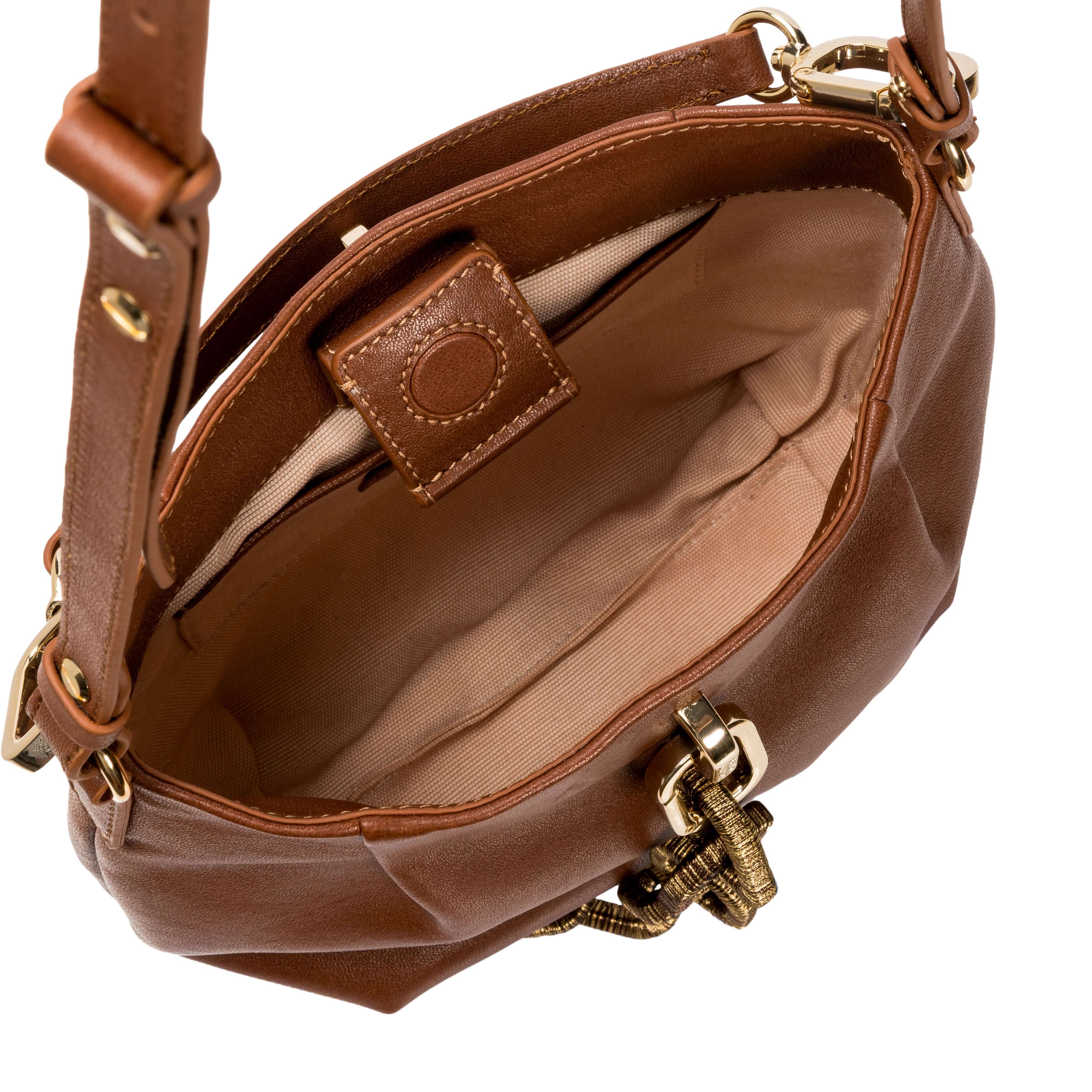Interior view of the Catena Camello Small Shoulder Pouch, showcasing its spacious compartment and stylish design.